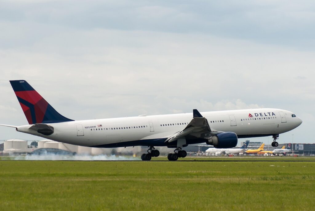 Delta Business Class suite showcasing plush leather seat, privacy doors, luxe amenities.