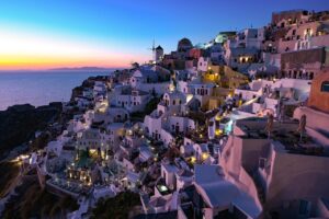 Tourists at a Greek island paying higher hotel and travel taxes at check-in.