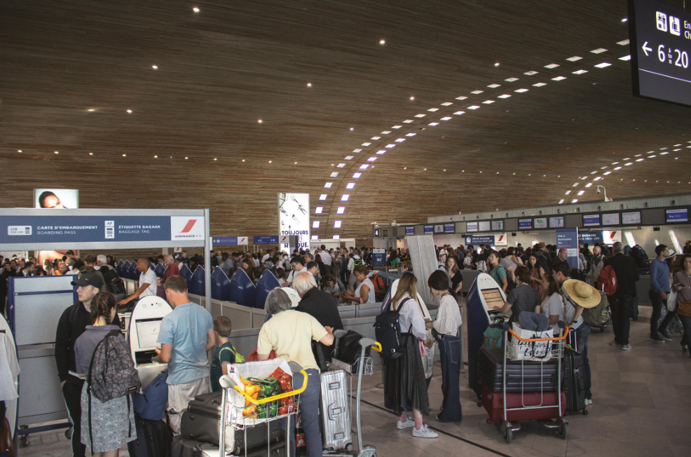 Travelers viewing traditional and modern art installations at Hong Kong International Airport.