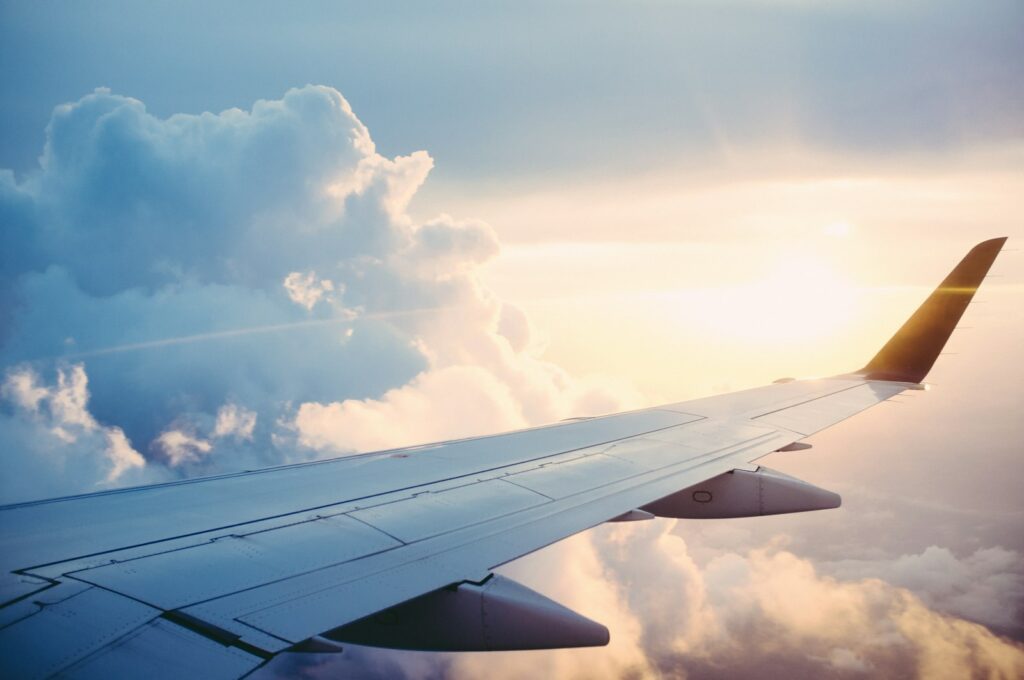 Airplane in flight representing OTA AI trip planning and Booking Holdings experiments