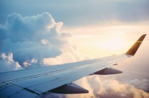 Airplane in flight representing OTA AI trip planning and Booking Holdings experiments